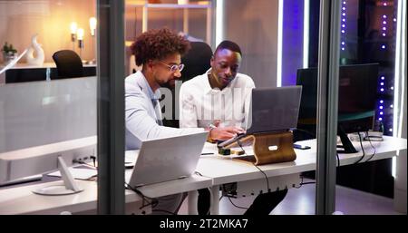 Business People Training On Computer. Young Workers In Office Stock Photo