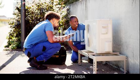 Air Conditioner Install. Commercial HVAC Maintenance Service Stock Photo