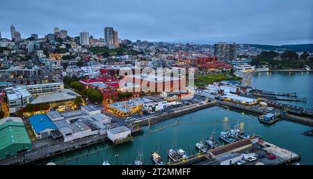 Aerial city lights in San Francisco at dusk near Hyde St Pier and Fishermans Wharf on coast Stock Photo