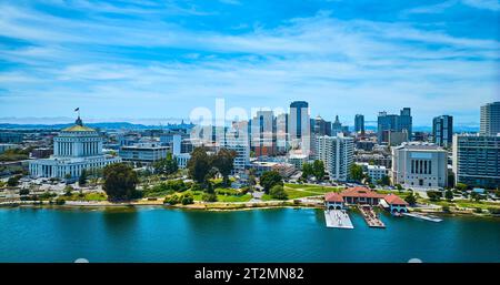 Low aerial of Oakland restaurant and downtown skyscrapers with courthouse Stock Photo