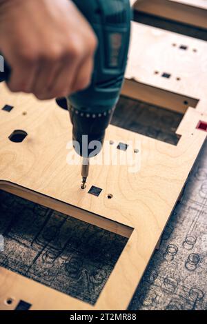 Man is working with electric screwdriver, hand tools concept Stock Photo