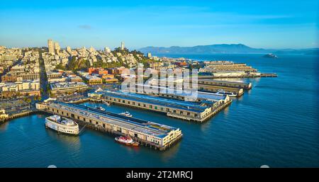 Sunrise aerial San Francisco piers with Coit Tower and Alcatraz Island in distance Stock Photo