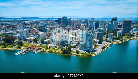 Wide aerial over Lake Merritt with downtown Oakland CA and distant San Francisco with bay Stock Photo