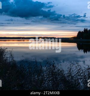 The sun going down over the coast Stock Photo