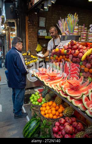 ISTANBUL,TURKEY-JUNE 7:Guys slicing watermelon to sell at their