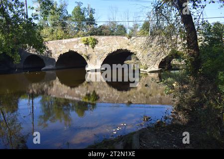 Old stone bridge over Millstone River in Kingston, New Jersey, on a clear, sunny day in early autumn. -01 Stock Photo