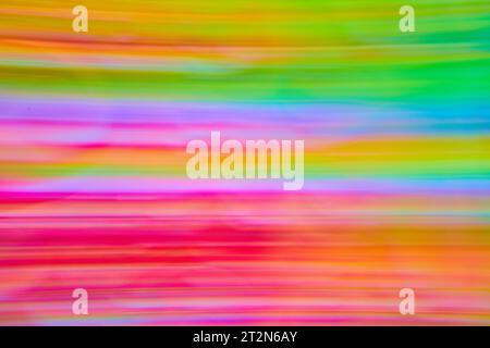 Colorful abstract streaks of tie dye colors ranging from hot pink to light green and yellow Stock Photo