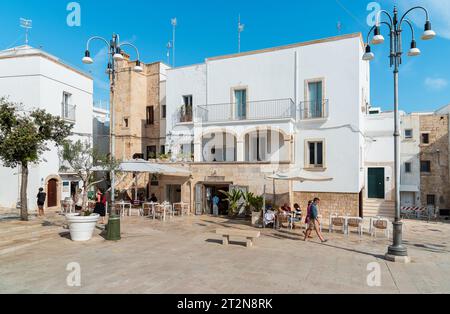 Polignano a Mare, Puglia, Italy - October 4, 2023: The square with bars and restaurants in the center of the Polignano a Mare village. Stock Photo