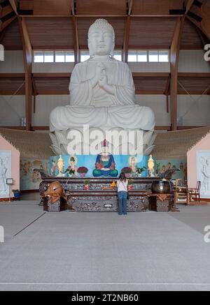 The interior of the Chuang Yen Buddhist Monastery in Carmel, Putnam Cty, New York showing the largest Buddha statue in the western hemisphere. Stock Photo