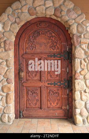 Ornate carved wood door with grape motif, Summerhill Pyramid Winery, Kelowna, British Columbia, Canada Stock Photo