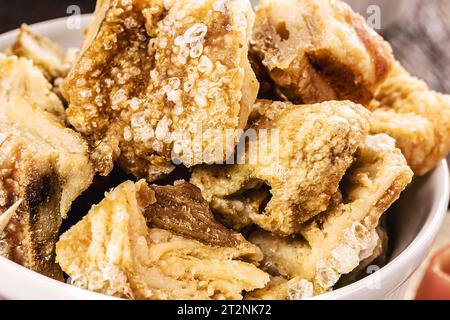 Crackling bowl, Brazilian appetizer made by frying bacon, leather or meat and lots of fat, taken from the pork belly. Stock Photo