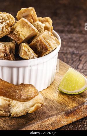 Crackling bowl, Brazilian appetizer made by frying bacon, leather or meat and lots of fat, taken from the pork belly. Stock Photo