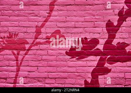 Painted pink brick wall with abstract dark pink and hot pink flowers on stems background asset Stock Photo