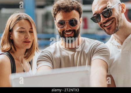 Young Adult Executives Collaborating on a Successful Marketing Strategy Using Technology Stock Photo