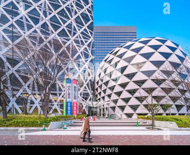 tokyo, shinjuku - dec 22 2022: Entrance of the glass facades of the iconic cocoon-shaped and golf-ball structure of the skyscrapers of HAL school Stock Photo