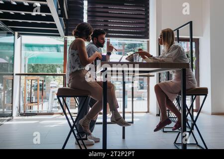 Efficient Multiracial Team Analyzing Reports for Successful Business Planning Stock Photo