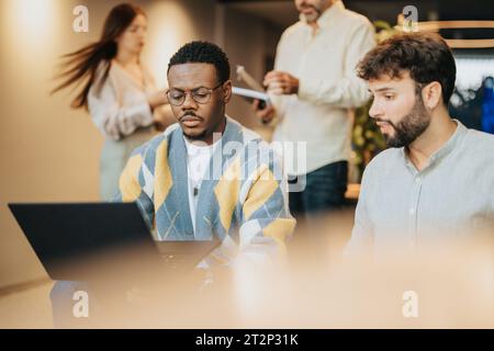 Multiracial Group of Confident Employees Discussing Business Strategies in a Modern City Center Co-Work Space Stock Photo
