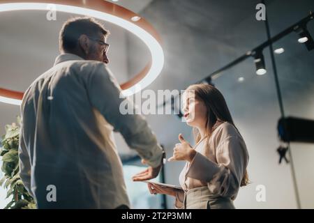 Business Leaders Discussing Efficiency and Work Outcomes in Collaborative Meeting Stock Photo