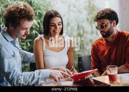 Collaborative Architects and Engineers Discussing Blueprint at Coffee Bar Stock Photo