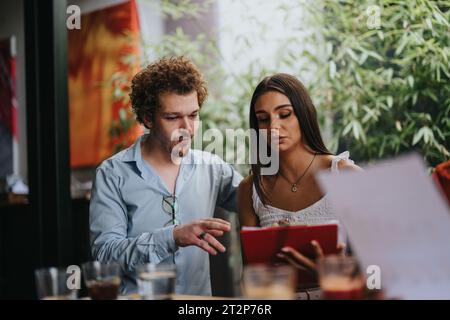 Successful Collaboration Between Architects and Engineers Discussing Blueprint at a Coffee Bar Stock Photo