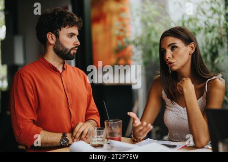 Multidisciplinary team of architects, engineers, and designers discussing blueprint details and project development for urban planning. Stock Photo