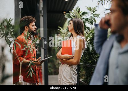 Innovative Architects Collaborating on Construction Project with Blueprint on Tablet Stock Photo