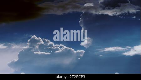 Heavenly cloudscape with thin patches of blue haze from distant wildfires on a beautiful summer afternoon. Stock Photo