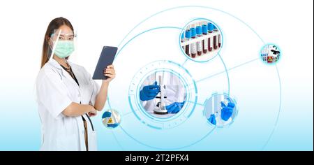 A confident female doctor, garbed in lab coat, holds a tablet computer showing sign of success, connection, technology and social network. Her focused Stock Photo