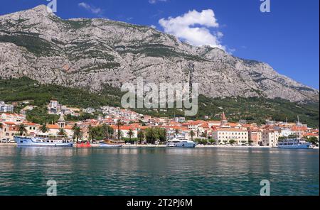 Panorama and landscape of Makarska resort and its harbour with boats and blue sea water in Croatia Stock Photo