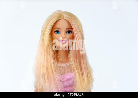 October 9, 2023. Barnaul, Russia: Portrait of a Barbie doll with loose blond hair in a pink dress on a white background. Portrait of a Barbie. Stock Photo