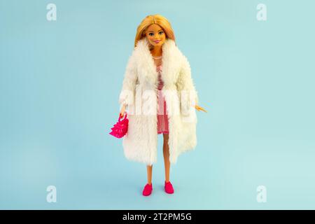 October 9, 2023. Barnaul, Russia: Barbie doll with loose blond hair standing on a blue background. Stock Photo