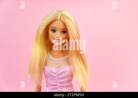 October 9, 2023. Barnaul, Russia: Portrait of a Barbie doll with loose blond hair on a pink background. Stock Photo