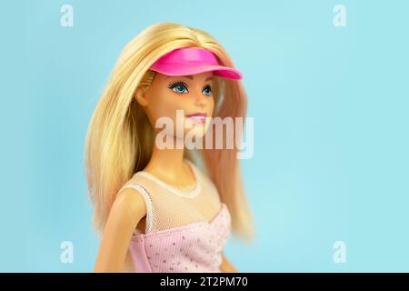 October 9, 2023. Barnaul, Russia: Portrait of a Barbie doll with loose blond hair on a blue background. Stock Photo