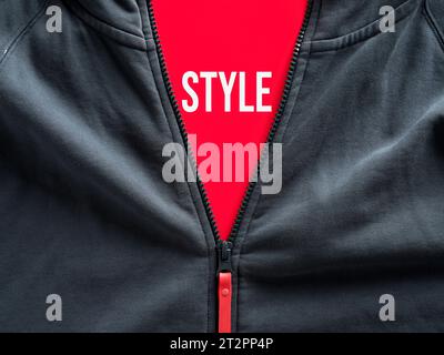 Opened zipper of a hoodie showing a red tag with the word style. Fashion and casual sportwear clothing. Stock Photo