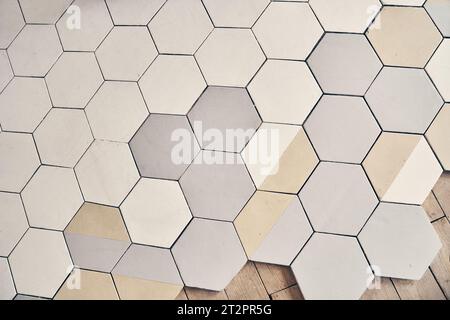 Unfinished geometric mosaic texture design for finishing the floor with a copy space. Abstract pattern, light ceramic tile floor. Concrete hexagonal paving stones for paving. High quality photo Stock Photo