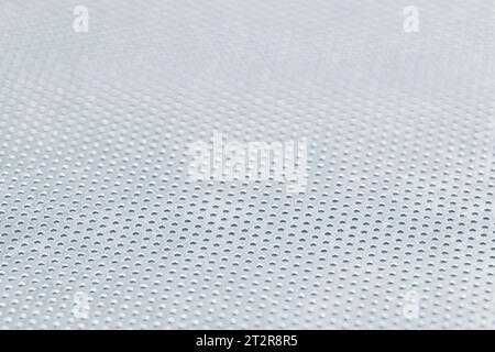 Abstract background of a stainless steel perforated sheet. Full frame Stock Photo