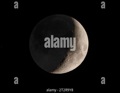 The waxing crescent moon glowing in the night sky over Ottawa, Canada Stock Photo