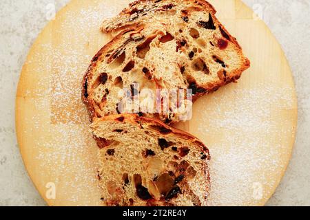 Cut panettone  on wooden board, Italian traditional Christmas cake Stock Photo
