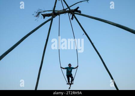 Kathmandu, Nepal. 20th Oct, 2023. A girl enjoy traditional bamboo swing, especially made and played on the occasion of the 'Dashain' festival in Kathmandu, Nepal, on October 20, 2023. (Photo by Abhishek Maharjan/Sipa USA) Credit: Sipa USA/Alamy Live News Stock Photo