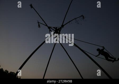 Kathmandu, Nepal. 20th Oct, 2023. A boy enjoy traditional bamboo swing, especially made and played on the occasion of the 'Dashain' festival in Kathmandu, Nepal, on October 20, 2023. (Photo by Abhishek Maharjan/Sipa USA) Credit: Sipa USA/Alamy Live News Stock Photo