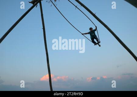 Kathmandu, Nepal. 20th Oct, 2023. A girl enjoy traditional bamboo swing, especially made and played on the occasion of the 'Dashain' festival in Kathmandu, Nepal, on October 20, 2023. (Photo by Abhishek Maharjan/Sipa USA) Credit: Sipa USA/Alamy Live News Stock Photo