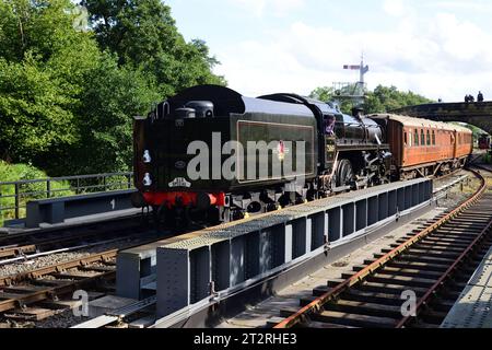 Running tender first, BR Standard Class 4 No 75069 arrives at Goathland on the North Yorkshire Moors Railway during its 50th anniversary gala. Stock Photo