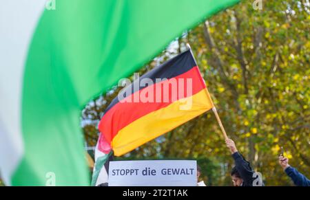 21 October 2023, Hesse, Frankfurt/Main: Rally participants wave Palestinian flags and a German flag on Opernplatz. A pro-Palestinian rally under the slogan 'Peace and Justice in the Middle East' takes place on Opernplatz. The Administrative Court of Frankfurt has lifted the ban on the anti-Israeli demonstration originally imposed by the city. Photo: Andreas Arnold/dpa Stock Photo