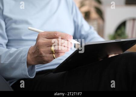 Hands of senior man using tablet PC. Stock Photo