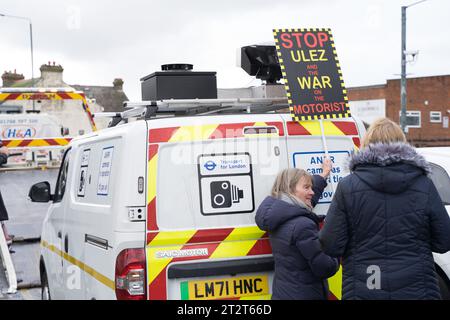 Greater London UK. 21st October 2023. Anti-ULEZ protestors block the mobile ULEZ camera with a placard written 'STOP ULEZ and the WAR on MOTORIST'. Credit: glosszoom/Alamy Live News Stock Photo