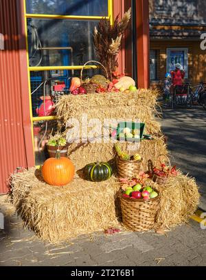 fall market display of pumpkins on bales of hay Stock Photo