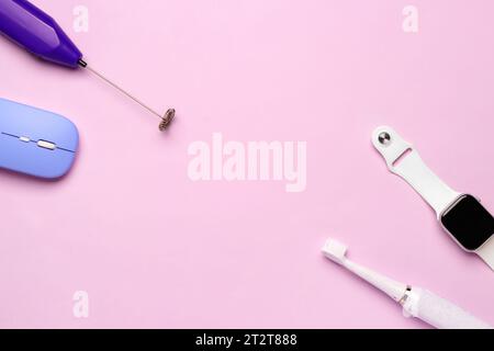Frame made of modern gadgets on pink background Stock Photo