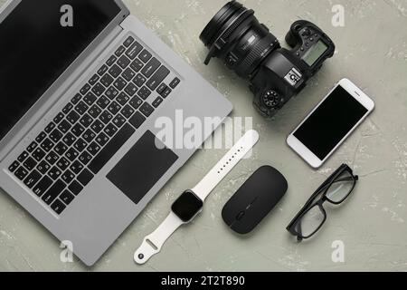 Modern gadgets with eyeglasses on grunge background Stock Photo