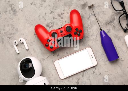 Modern gadgets with eyeglasses on grunge background Stock Photo