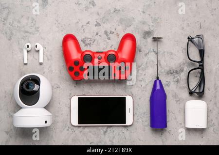 Modern gadgets with eyeglasses on grunge background Stock Photo